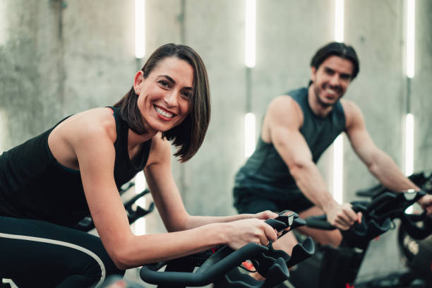 istock Couple training on exercise bike at gym. 2028231753