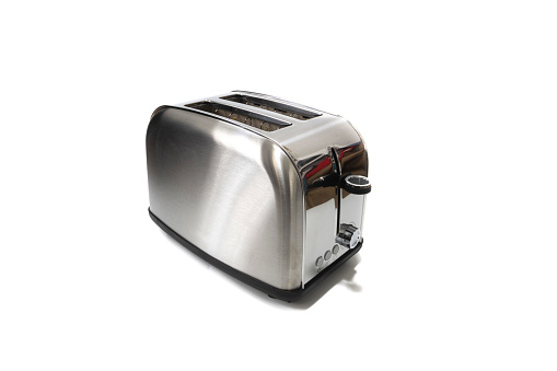 modern electric metallic toaster on grey wooden table in kitchen. electrical appliances for cooking.