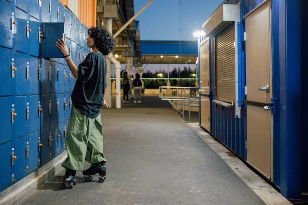 Woman on roller skates looking in a parcel locker