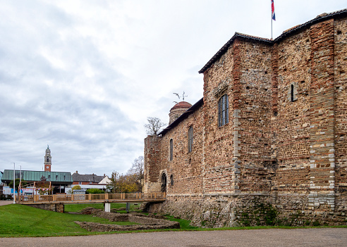 The main entrance to Colchester Castle in Colchester, Essex, Eastern England. Colchester Castle is the largest Norman keep in Europe, built on the foundations of the Roman Temple of Claudius and dates from 1076. It was constructed using Roman bricks and stone which were already locally available in large quantities. Colchester itself is known as Great Britain’s oldest recorded town and the Castle has been used variously as a military structure, a gaol and is now a museum dating back to 1860. The tower of the Town Hall can be seen in the background.