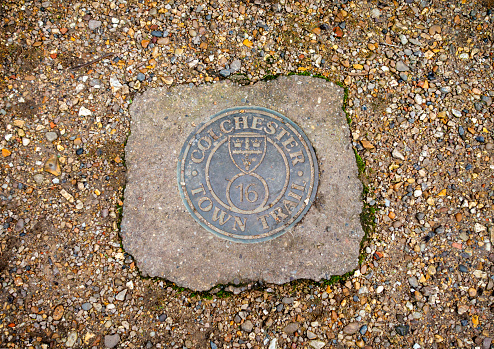 One of the plaques for the Town Trail in Colchester, Essex, Eastern England, which direct tourists along a walk around the city: this is plaque number 16, the site of Colchester’s one-time most popular inn, the Three Cups, now gone.