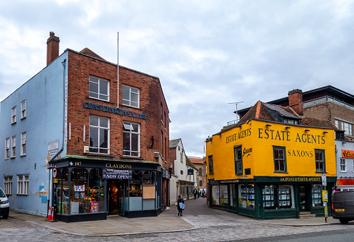 Shops on the junction of Museum Street and the High Street in Colchester, Essex, Eastern England, on an overcast autumn day.