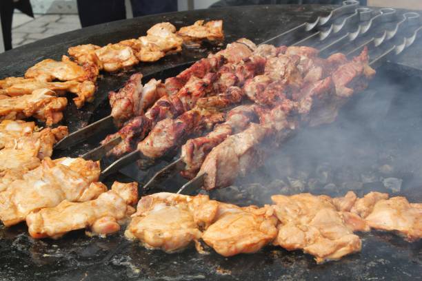 istock Kebab meat skewers grilling and chicken on fire at backyard. Marinated shashlik, meat grilling on metal skewer. Greek grill food. Outdoor barbecue cooking. Street food concept 2028278954