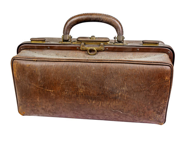 Old brown and dusty doctor bag Old dusty and scratched brown doctors bag with handle isolated on white leather medical bag stock pictures, royalty-free photos & images