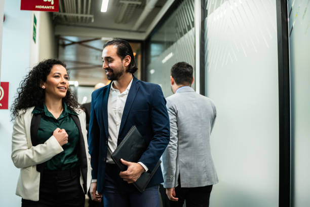 istock Coworkers walking and talking at office 2028291138