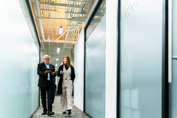 istock Senior businessman walking and talking with employee at office 2028291668