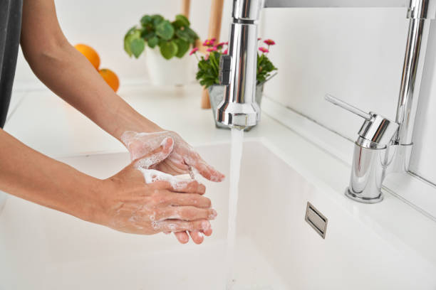 istock Crop person washing hands in sink 2028301780
