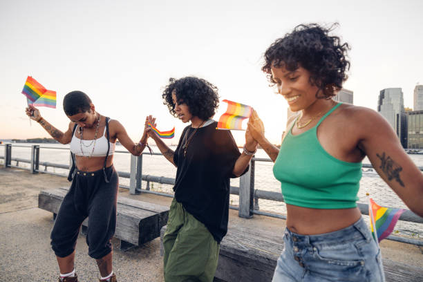 istock Freestyler roller skate dancers performing for LGBTQIA+ rights holding rainbow flags 2028340727