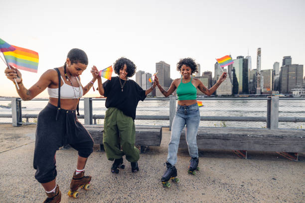 istock Freestyler roller skate dancers performing for LGBTQIA+ rights holding rainbow flags 2028341765