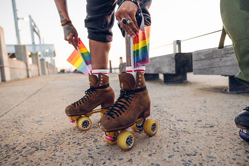 Activists put rainbow flags on their roller skates during a protest.