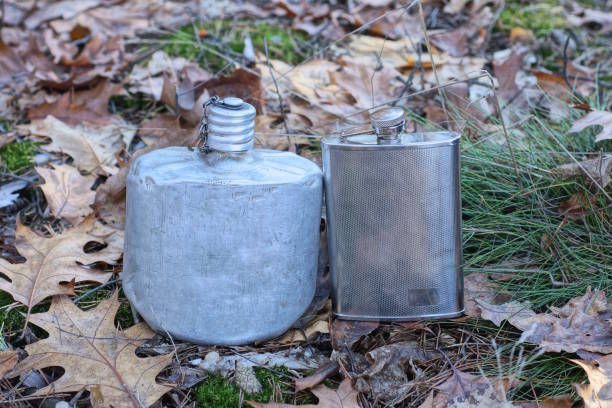istock a set of two old army flasks stand on the ground 2028347004