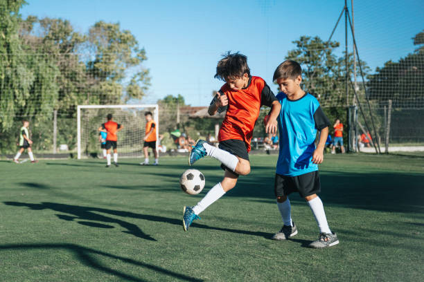 istock two boys  fighting for soccer ball in match 2028366425