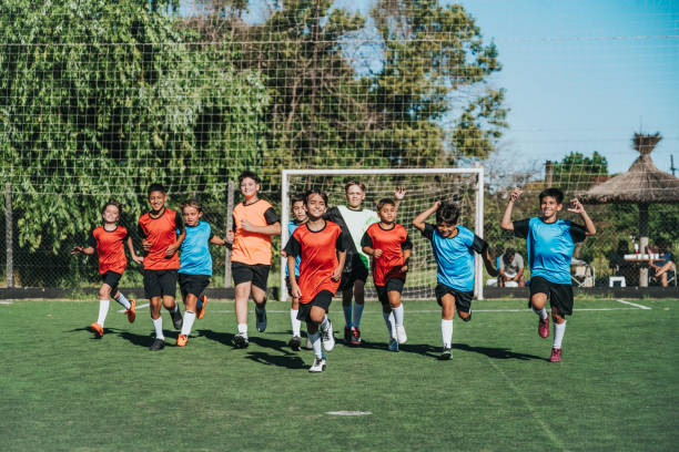 istock two boy soccer teams running on pitch together 2028367466