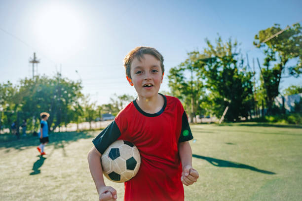 istock portrait of cheering soccer boy 2028371164