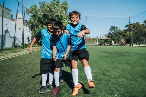istock three soccer boys cheering after scoring a goal 2028372740