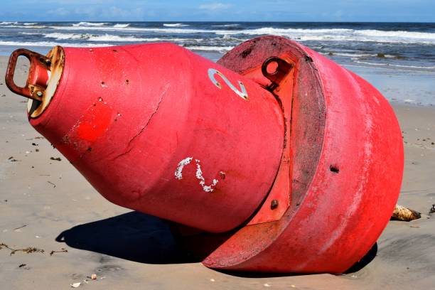 istock Large buoy washed up on the ocean beach. 2028374307