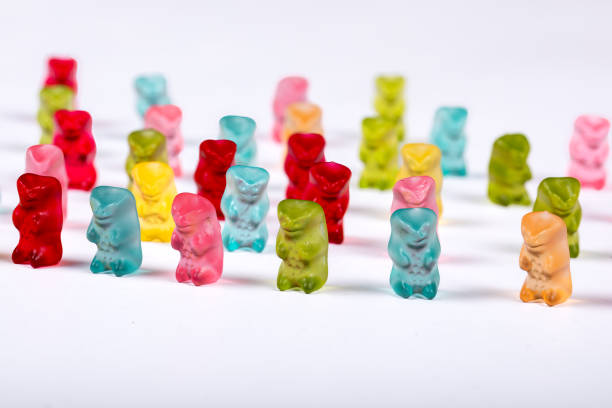 istock Colorful Gummy Bear Army Marching on White Background - Fun Candy Parade Concept 2028391694