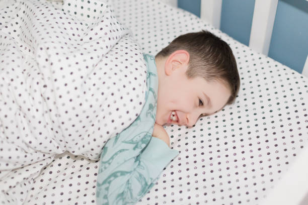 istock Happy caucasian schoolboy in bed 2028395970