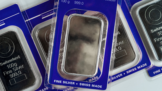 Several minted silver bars weighing 100 grams in transparent blister pack