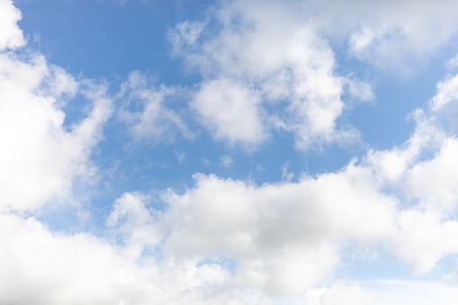 Nature background abstract photo of the beauty of the sky adorned with white, billowing cumulus clouds, creating an abstract texture against the vast expanse of bright blue. This panoramic view offers a captivating angle, showcasing the ethereal dance of clouds amidst the boundless sky. Immerse yourself in the tranquility of nature's canvas, where the interplay of light and shadow creates an ever-changing spectacle of wonder