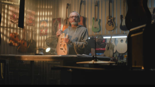 istock Mature carpenter, craftsman stands in modern workshop and looks at camera 2028422308