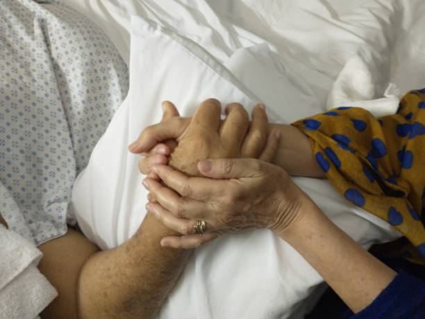istock hands holding each other in the hospital room, accompaniment 2028426043