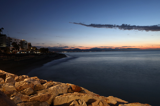 View from Torremolinos towards Malaga just before sunrise. Costa del Sol, Spain.