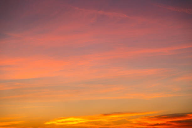 Behold the captivating beauty of nature's spectacle as the sky blazes with fiery hues of orange during sunset. This stunning backdrop sets the sky ablaze with vibrant colors, offering a breathtaking and mesmerizing sight to behold