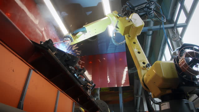 Metal iron laser argon welding robot in factory. Industrial robotics. Automation of work. Manufacture of industrial equipment.