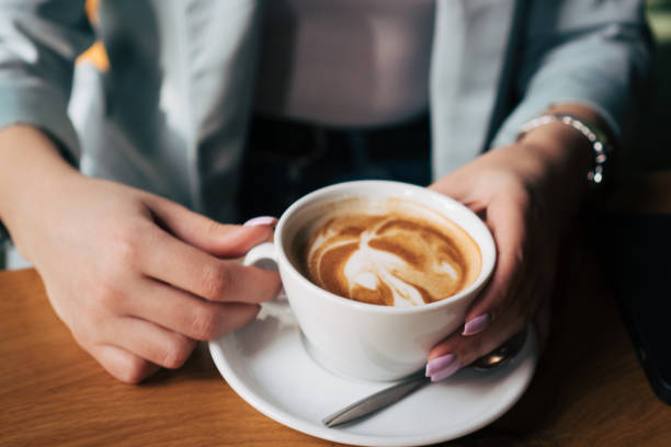 istock woman's hands holding cup of coffee 2028506038