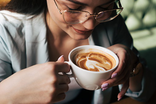 Young woman enjoying coffee.