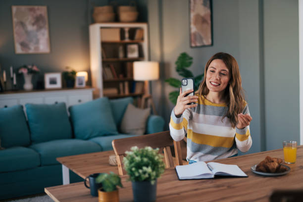 istock Friendly lady speaking with smartphone at home. 2028508143