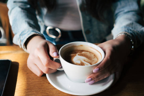 istock woman's hands holding cup of coffee 2028510211