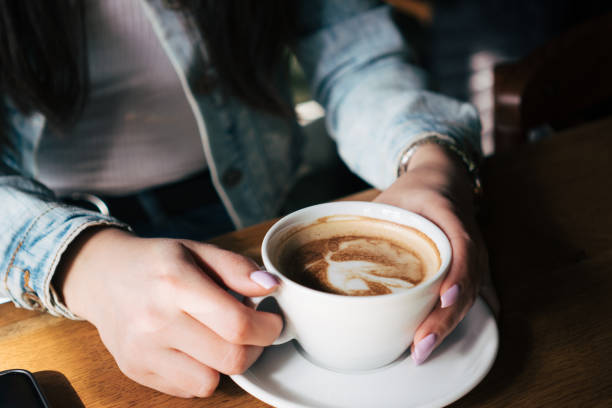 istock woman's hands holding cup of coffee 2028512805