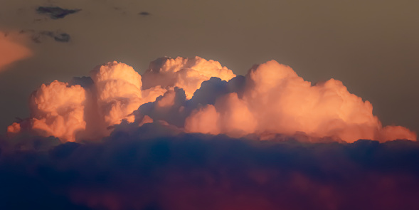 Dreamy photo of a cloud floating away at sunset, where will it venture off to in the shadows of nightfall?