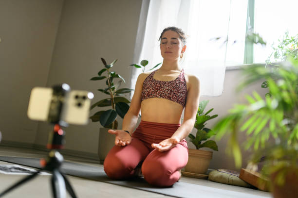 istock Woman practicing yoga at home, online lesson 2028543829