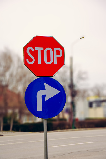 stop sign and right turn sign in traffic