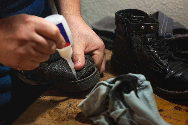 istock Shoemaker's hands gluing shoe soles 2028594349