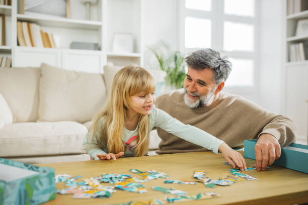 istock Little girl playing with grandfather 2028598067