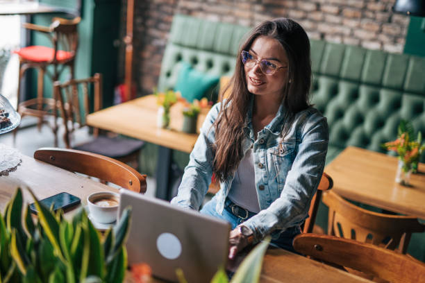 istock A young woman works at a laptop in a cafe. 2028608521