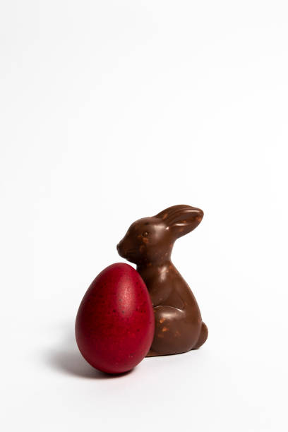 istock Red painted easter egg and chocolate bunny isolated on a white background 2028624249