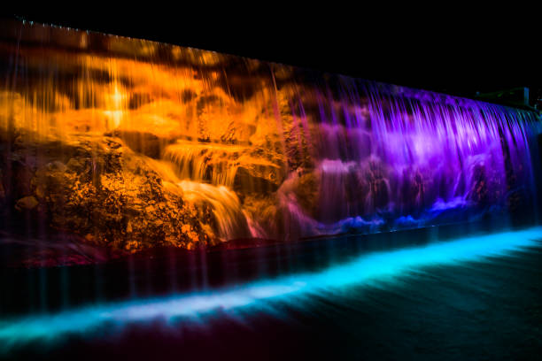 The water flows through the lights with beautiful colors at night.
