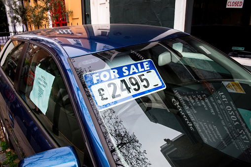 London, United Kingdom - Mar 9, 2017: For sale signage on the windshield of blue car with a price of 2495 UK pounds