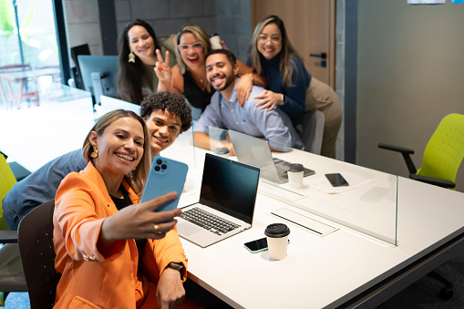 Group of friends taking selfie in office during leisure time