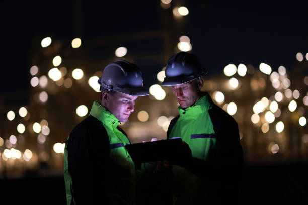 istock Engineers work on night shift against bokeh of power plant 2028719914