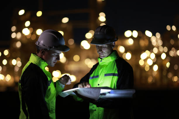 istock Engineers work on night shift against bokeh of power plant 2028720365