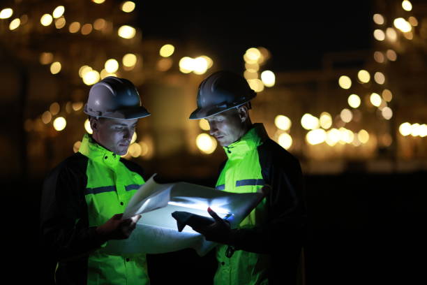istock Engineers work on night shift against bokeh of power plant 2028720367