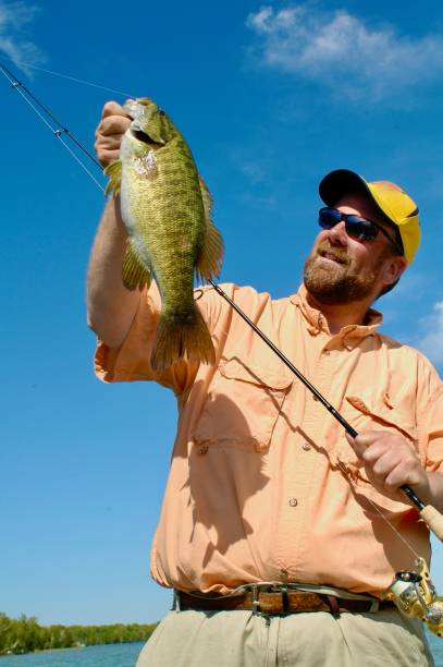 istock Angler with a smallmouth bass 2028741796