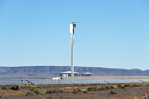 Solar power tower and solar panels on a solar farm