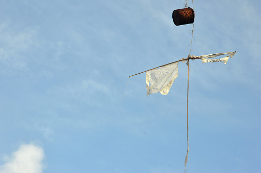 broken kite against blue sky